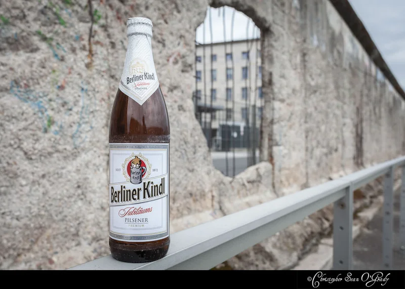 Berliner Kindl Pilsener on a railing at a Berlin Wall remnant