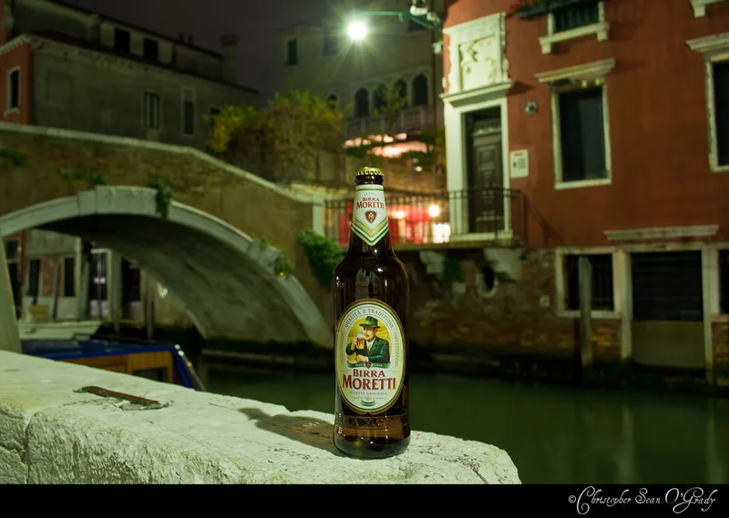 Birra Moretti at a Venice canal bridge at night