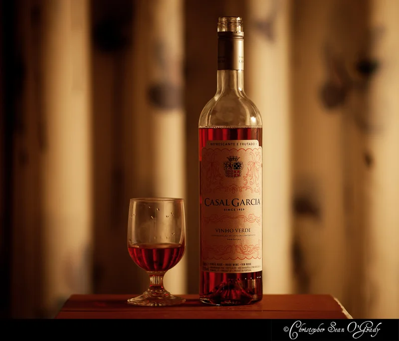 Casal Garcia Vinho Verde rose with a glass on a wooden table