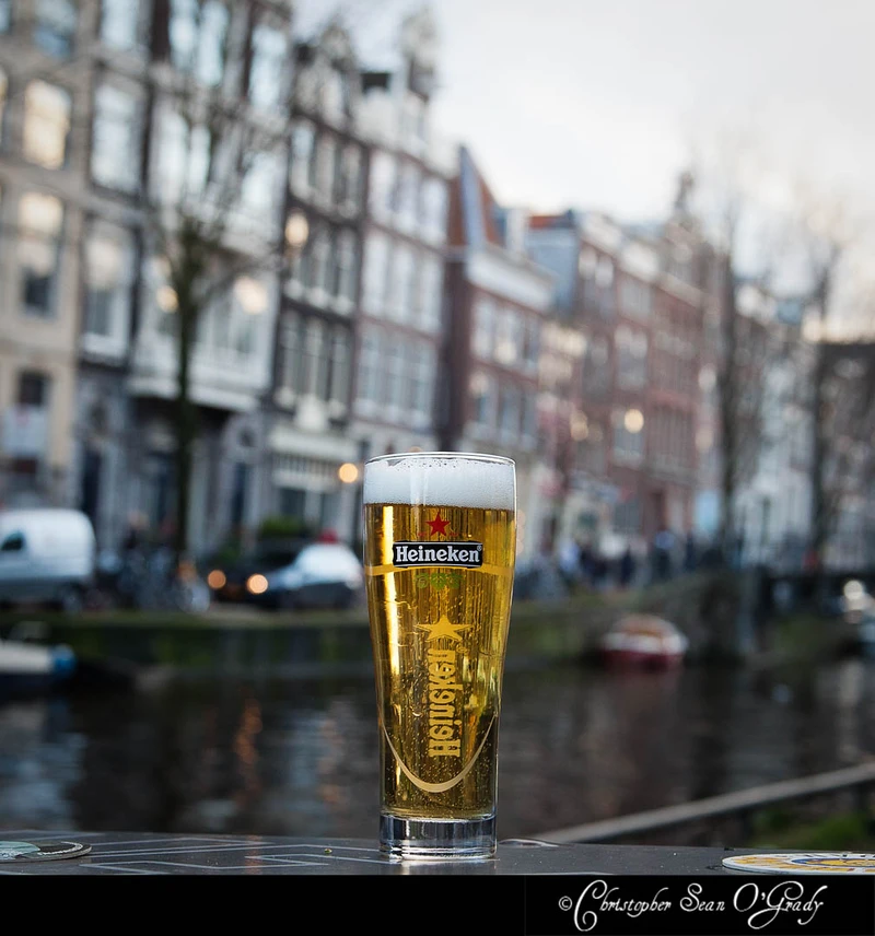 Heineken draft beer on an outdoor table along an Amsterdam canal