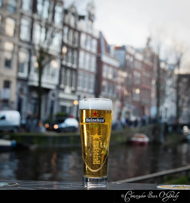 Heineken draft beer on an outdoor table along an Amsterdam canal