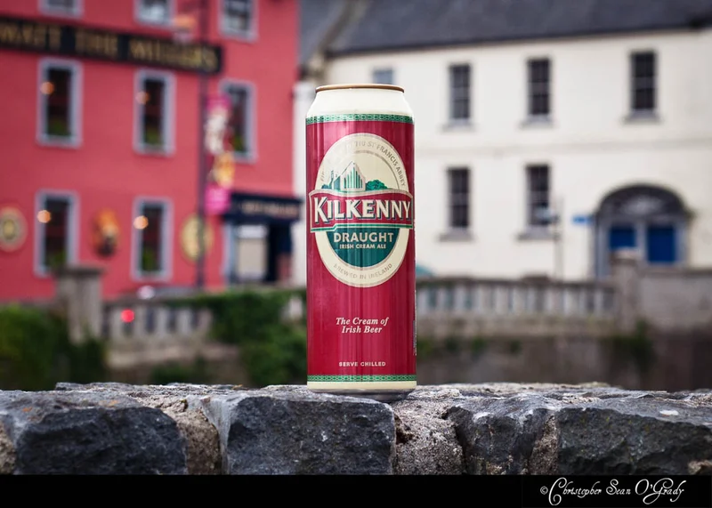 Kilkenny Draught Irish Cream Ale can on a stone wall in an Irish town