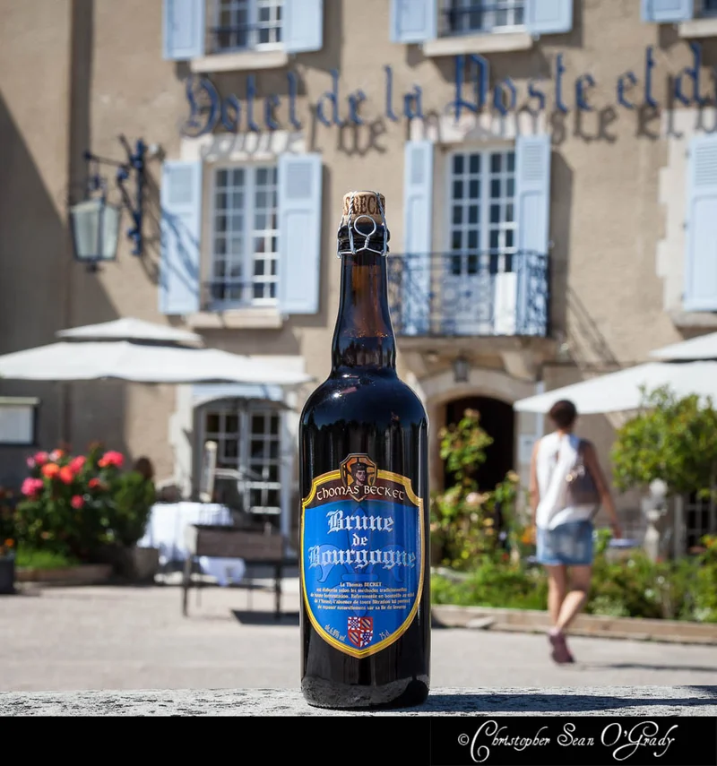 Thomas Becket Brune de Bourgogne bottle at a French hotel terrace in sunshine