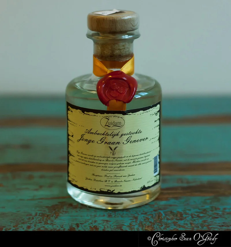 Zuidam Jonge Graan Genever bottle with wax seal on a turquoise wooden table