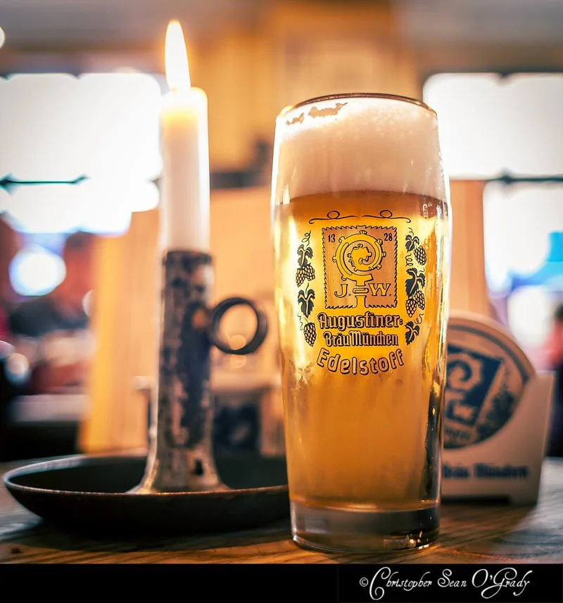 Augustiner Edelstoff beer with candle at a German beer hall