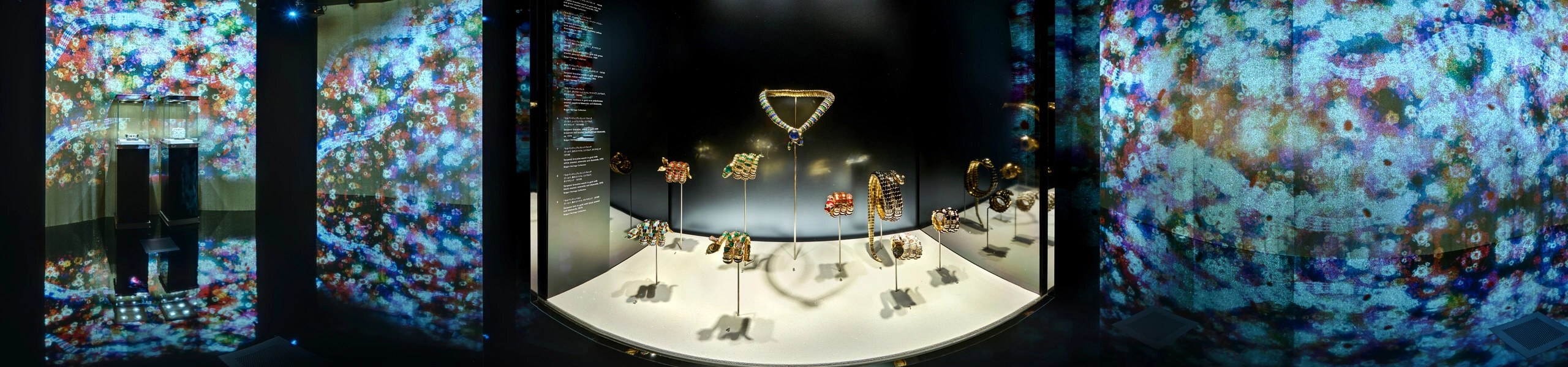 360 panorama of Bulgari Serpentiform jewellery display with gemstone pieces on white platform and projected kaleidoscope walls