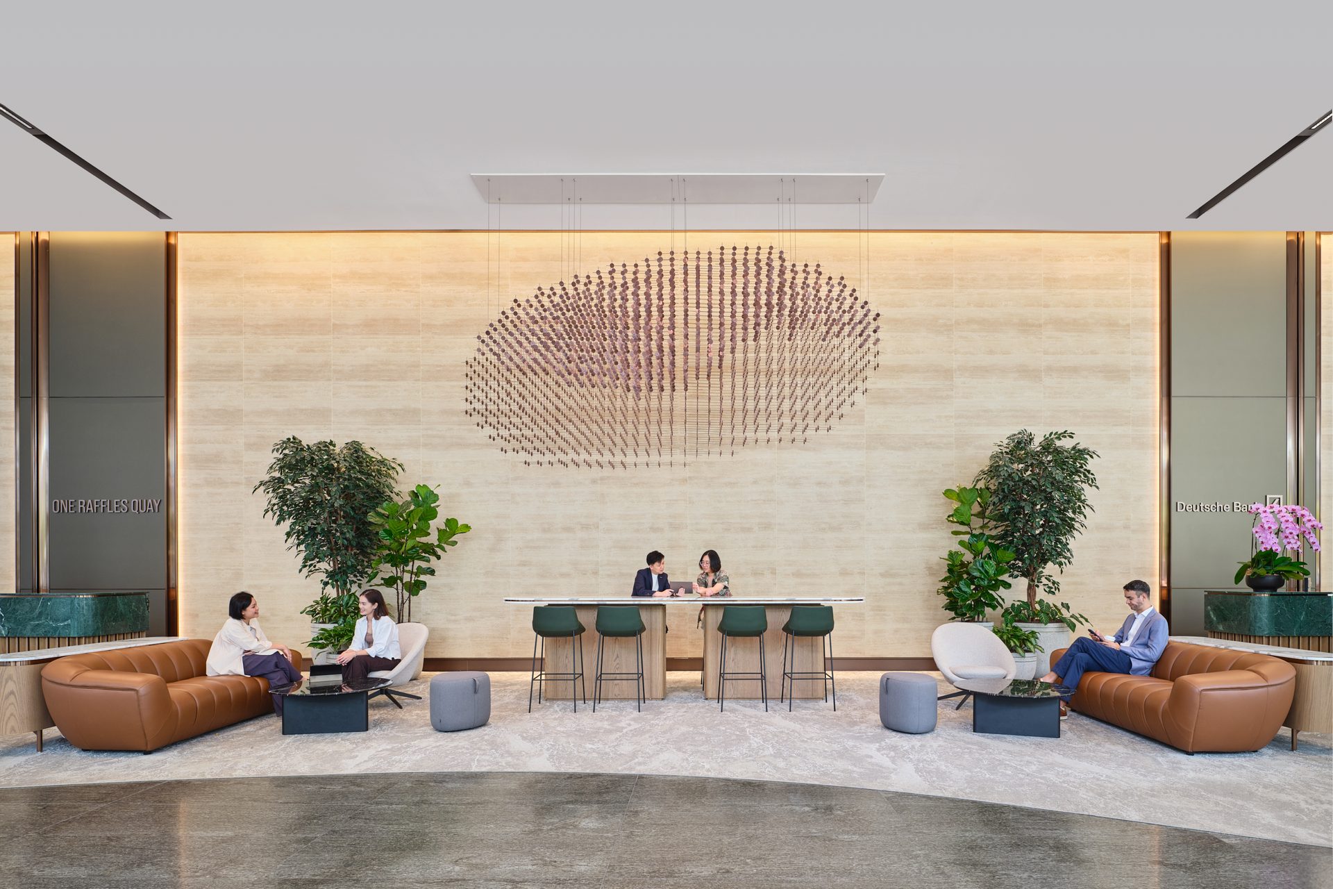 One Raffles Quay South Tower reception seating area with circular wall feature