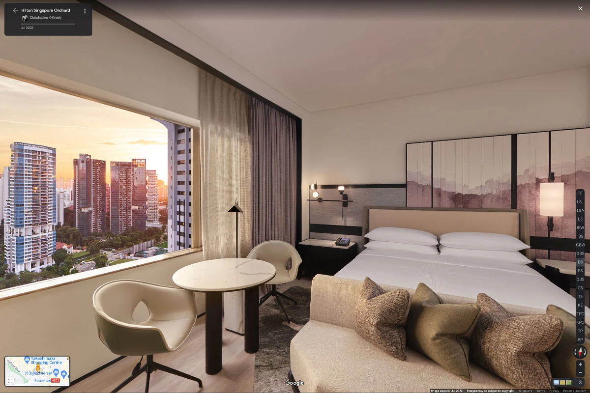 King bedroom with seating area and panoramic city views at Hilton Singapore Orchard hotel virtual tour