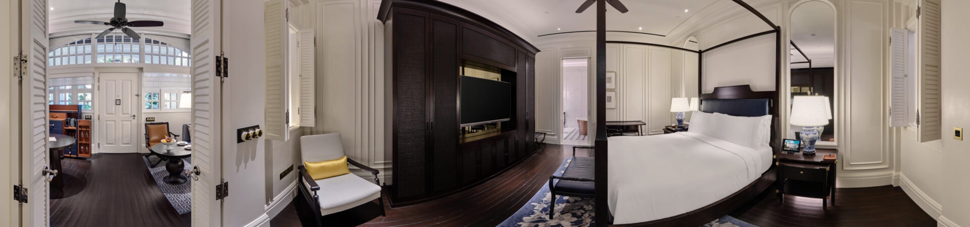 360 panorama of Raffles Hotel courtyard suite bedroom with four-poster bed, dark wood paneling and louvered doors