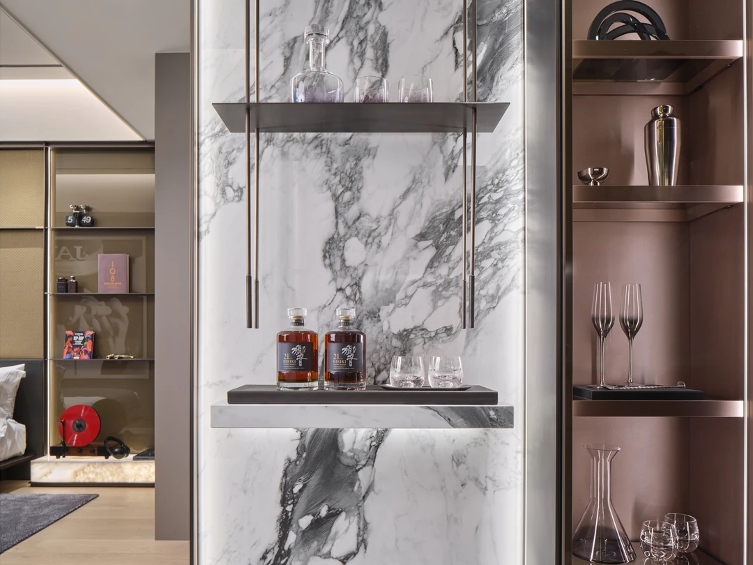 W Residences 1-bedroom showflat bar display with marble wall, glass shelving and bronze cabinetry, detail view
