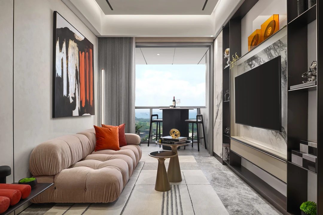 W Residences 1-bedroom showflat living room with curved sofa, balcony view and built-in TV wall