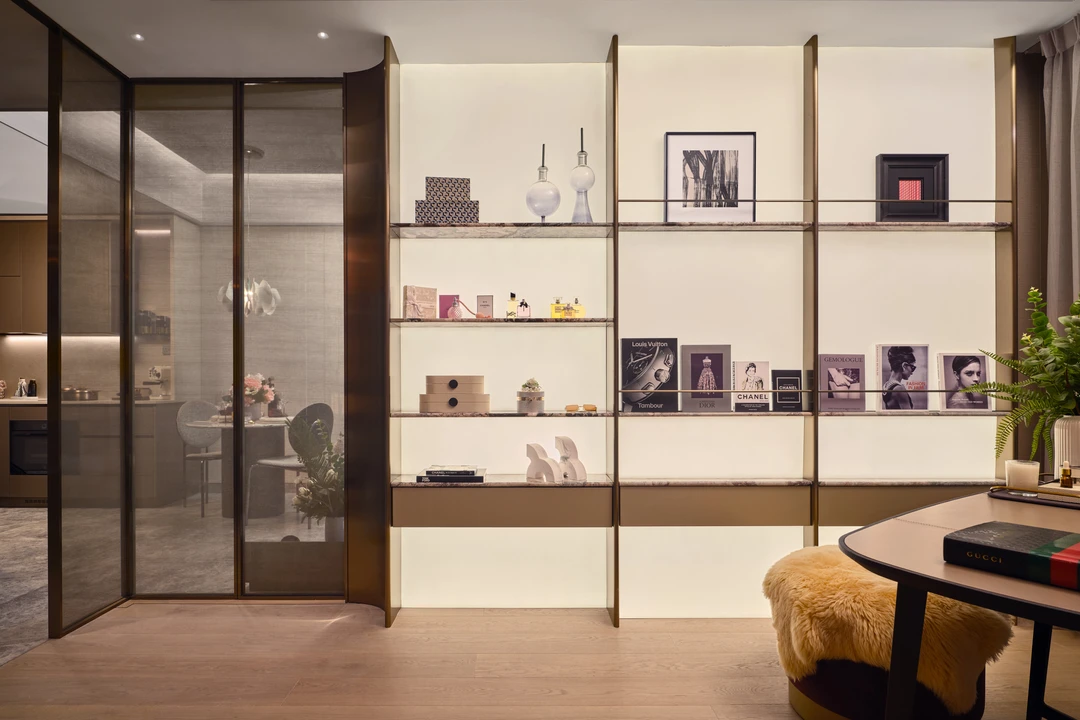 W Residences 2-bedroom showflat display shelving beside glass bedroom partition and curved study table