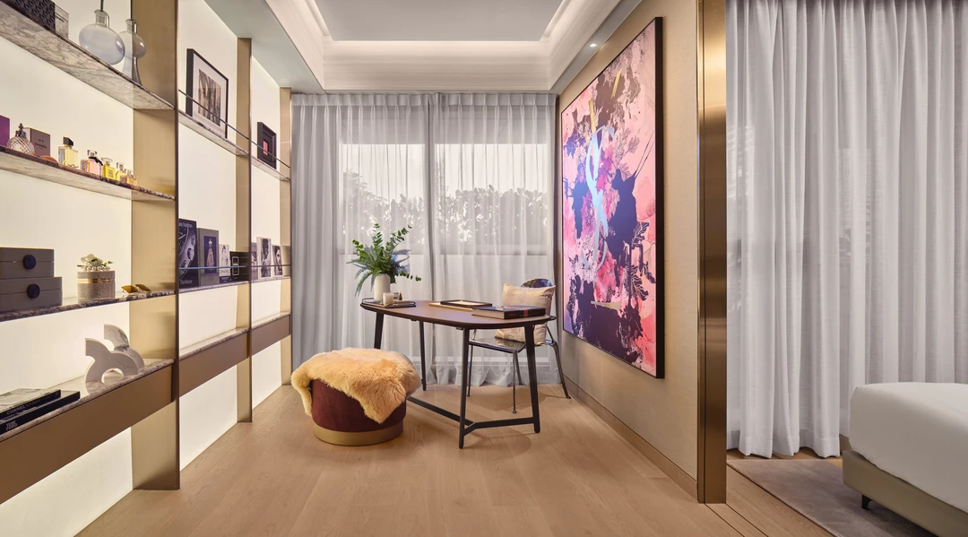 W Residences 2-bedroom showflat study corner with display shelves, lounge chair and pink feature artwork