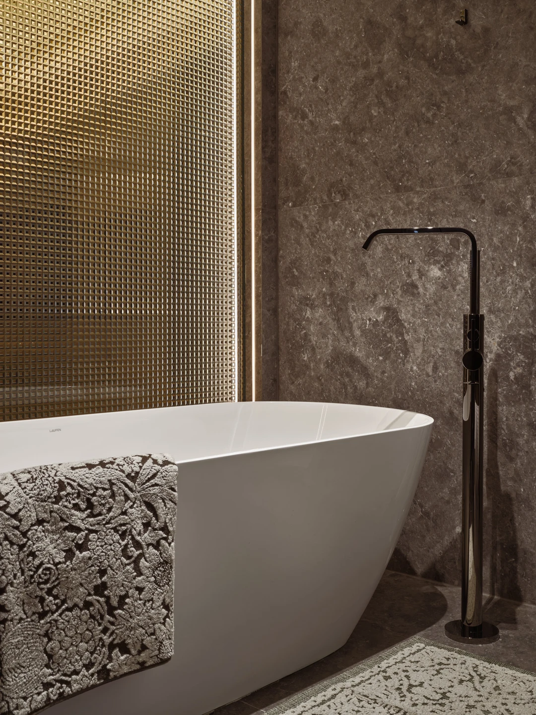 W Residences 5-bedroom showflat bath detail with freestanding tub, stone surround and fluted glass shower