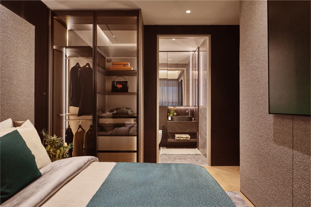 W Residences 5-bedroom showflat bedroom with open wardrobe, mirror vanity and layered bed styling