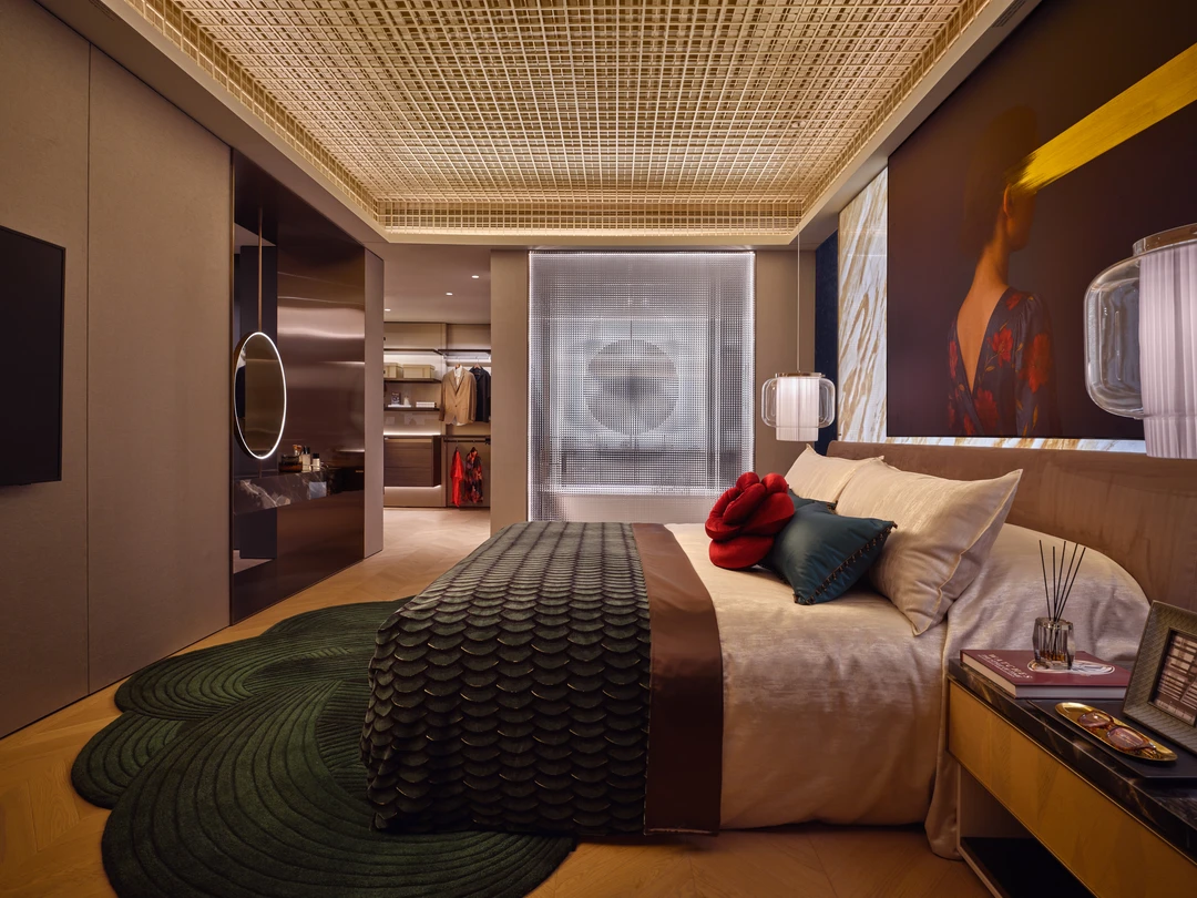 W Residences 5-bedroom showflat master bedroom with warm lighting, dark green bedding and art wall