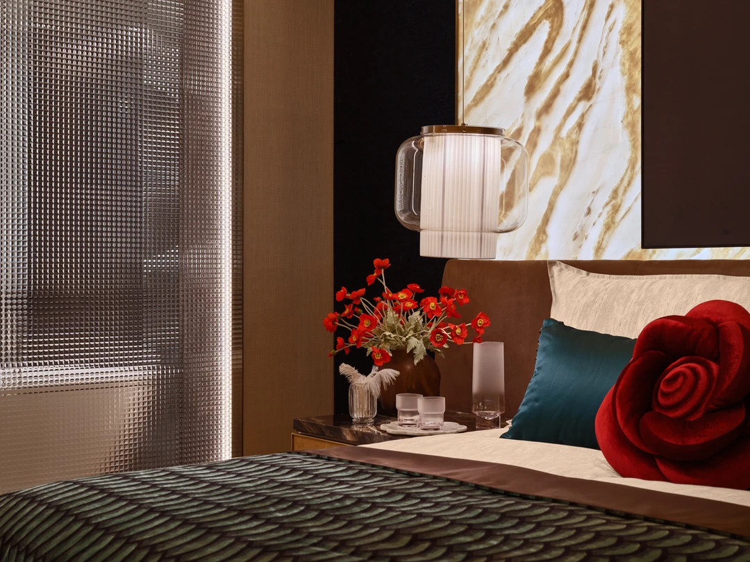 W Residences 5-bedroom showflat master bedroom bedside detail with red rose cushion and city view