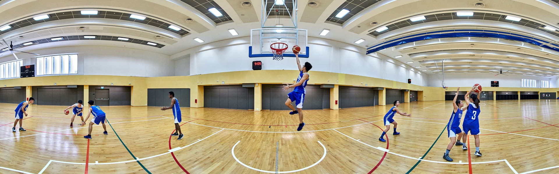360 panorama of Ngee Ann Polytechnic indoor sports hall with students playing basketball on timber court
