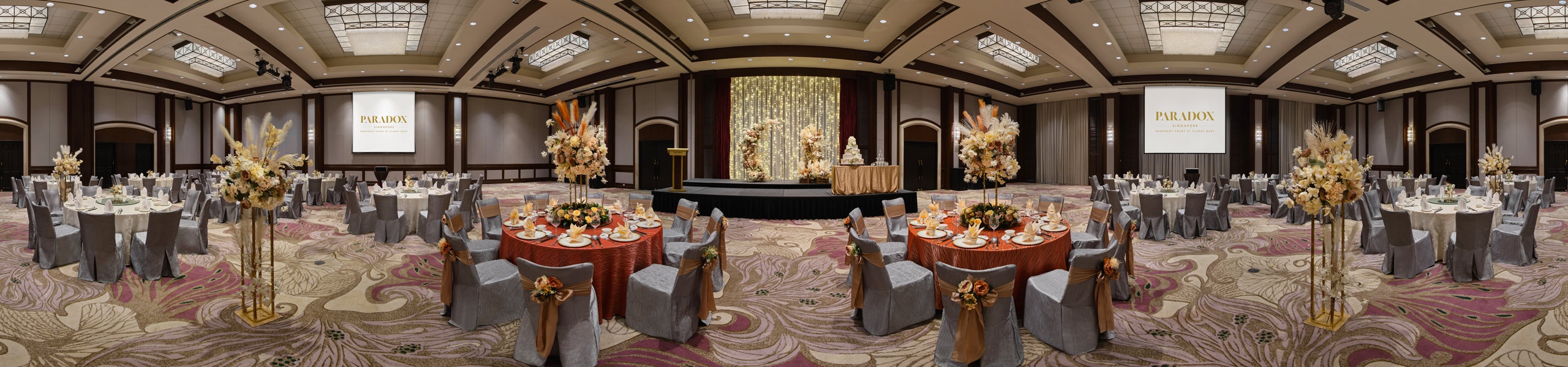360 panorama of Paradox Singapore ballroom with bohemian wedding setup, round tables, and floral centrepieces