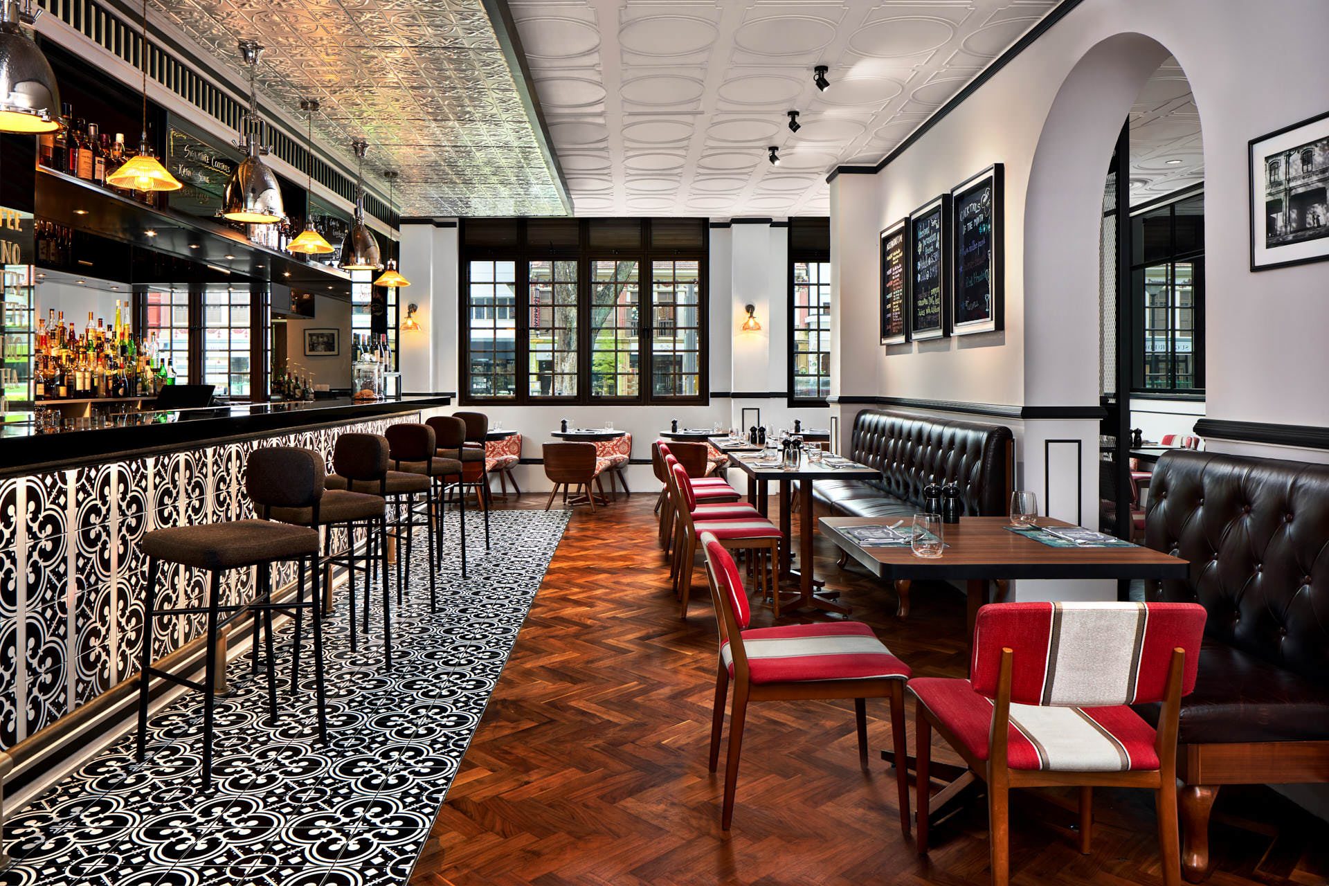 Colonial-style Baba Chews bar with pressed tin ceiling and herringbone floor