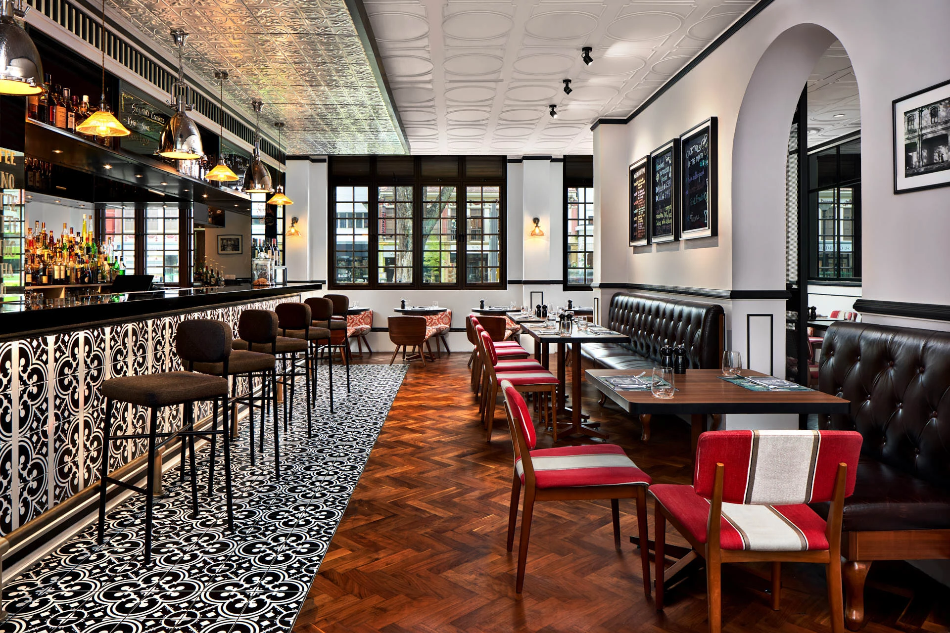Colonial-style Baba Chews bar with pressed tin ceiling and herringbone floor