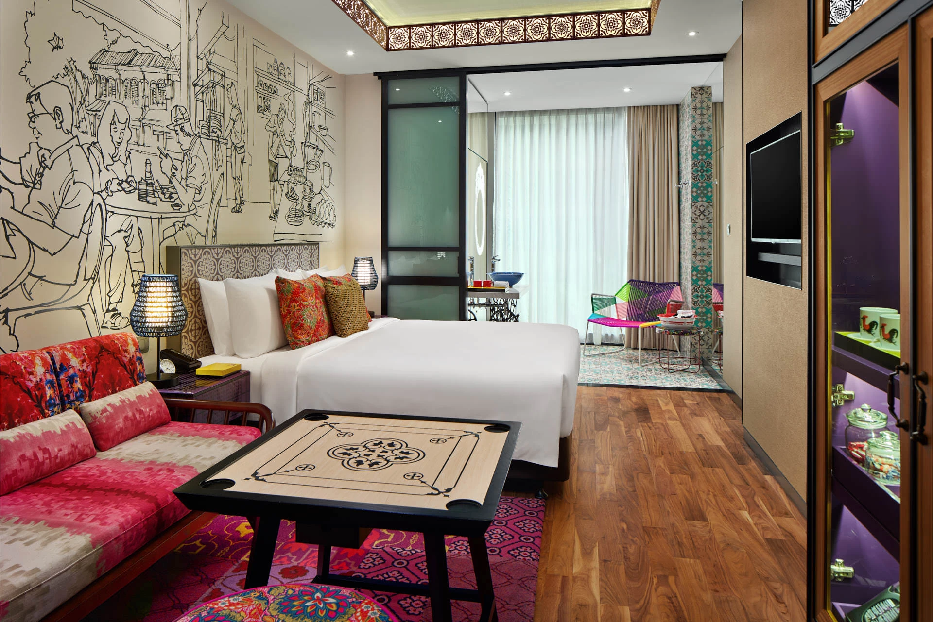Peranakan-inspired king room with ikat sofa, street art mural and carrom table