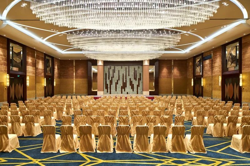 Theatre-style ballroom with mirrored stage and crystal chandelier — Crowne Plaza Tianjin Binhai event photography