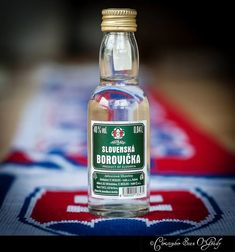Nicolaus Slovenska Borovicka miniature bottle on a patterned tablecloth