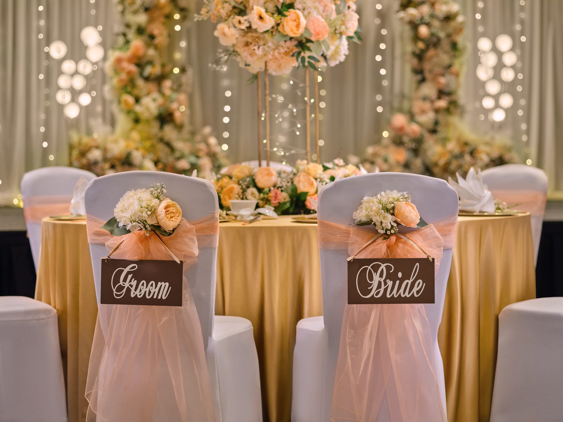 Bride and groom chairs with hydrangea posies and floral arch backdrop - voco Orchard Singapore wedding venue photography