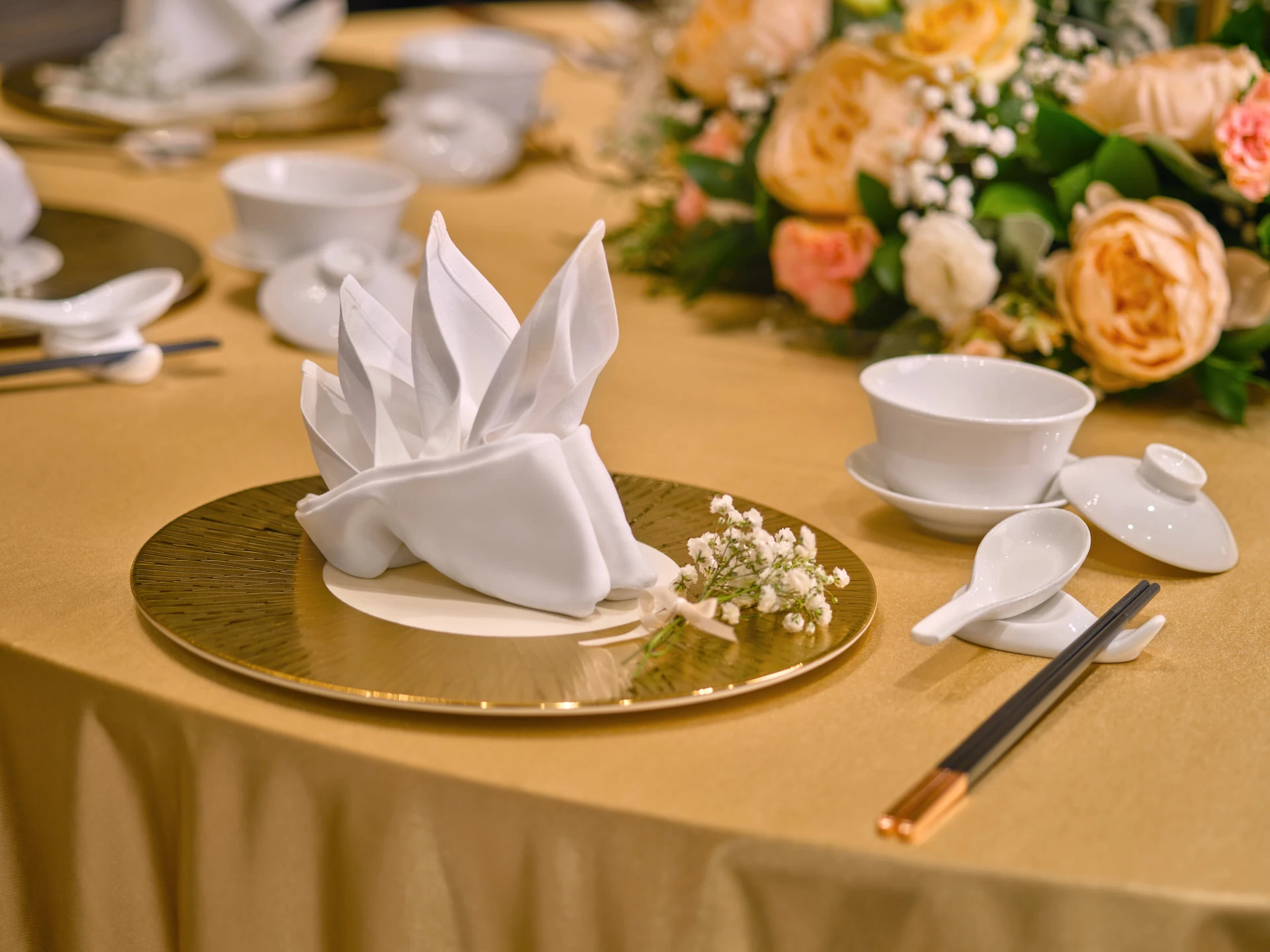 Chinese banquet place setting with gold charger, teacup and baby's breath - voco Orchard Singapore wedding photography