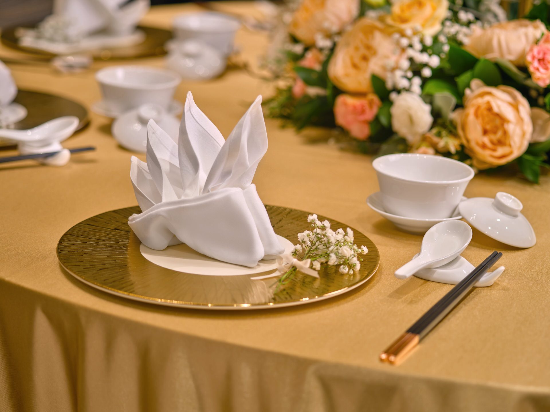 Chinese banquet place setting with gold charger, teacup and baby's breath - voco Orchard Singapore wedding photography