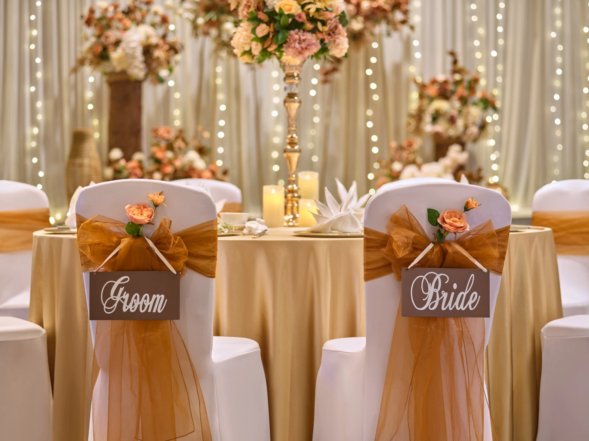 Sweetheart chairs with amber sashes and wooden name signs - voco Orchard Singapore wedding venue photography