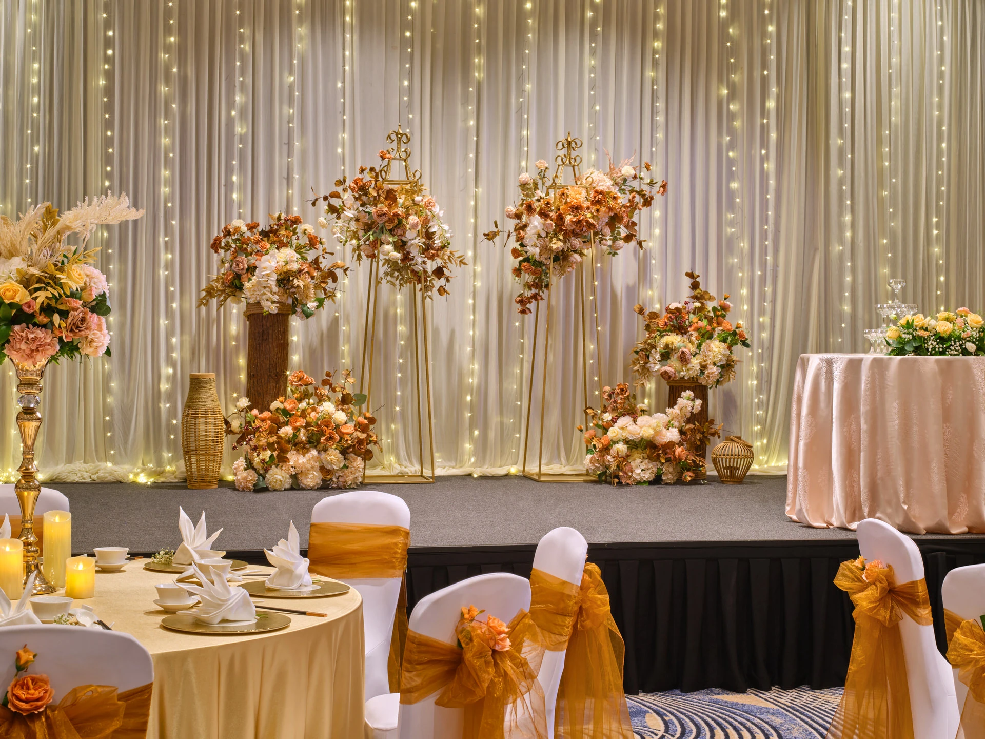 Wedding stage with rustic florals, pampas grass and fairy-light curtain backdrop - voco Orchard Singapore event photography