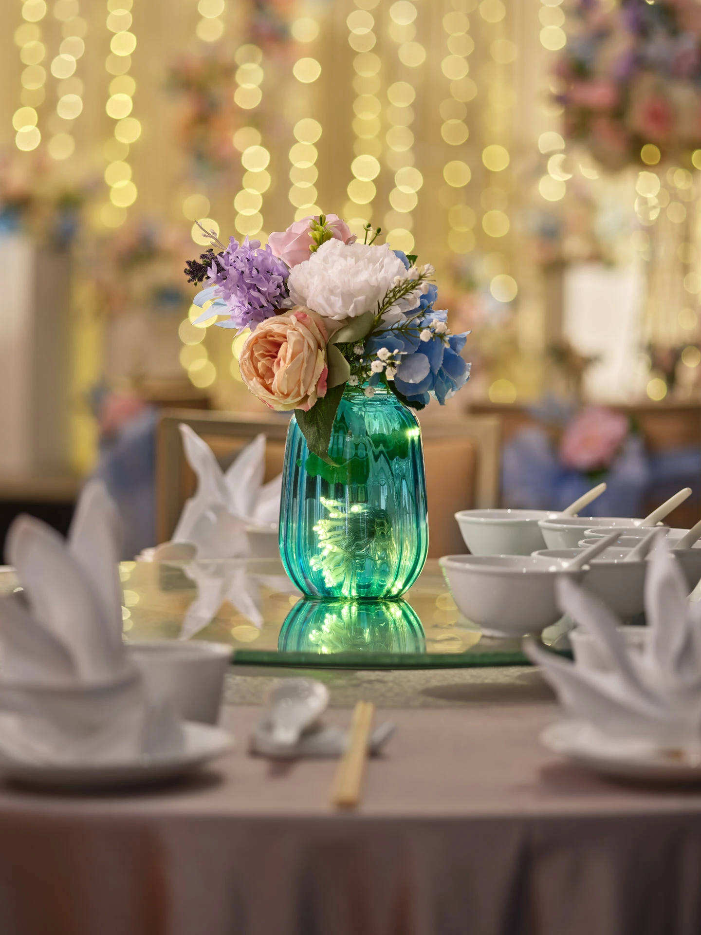 Teal glass vase centrepiece with fairy lights and pastel floral posy - voco Orchard Singapore wedding photography
