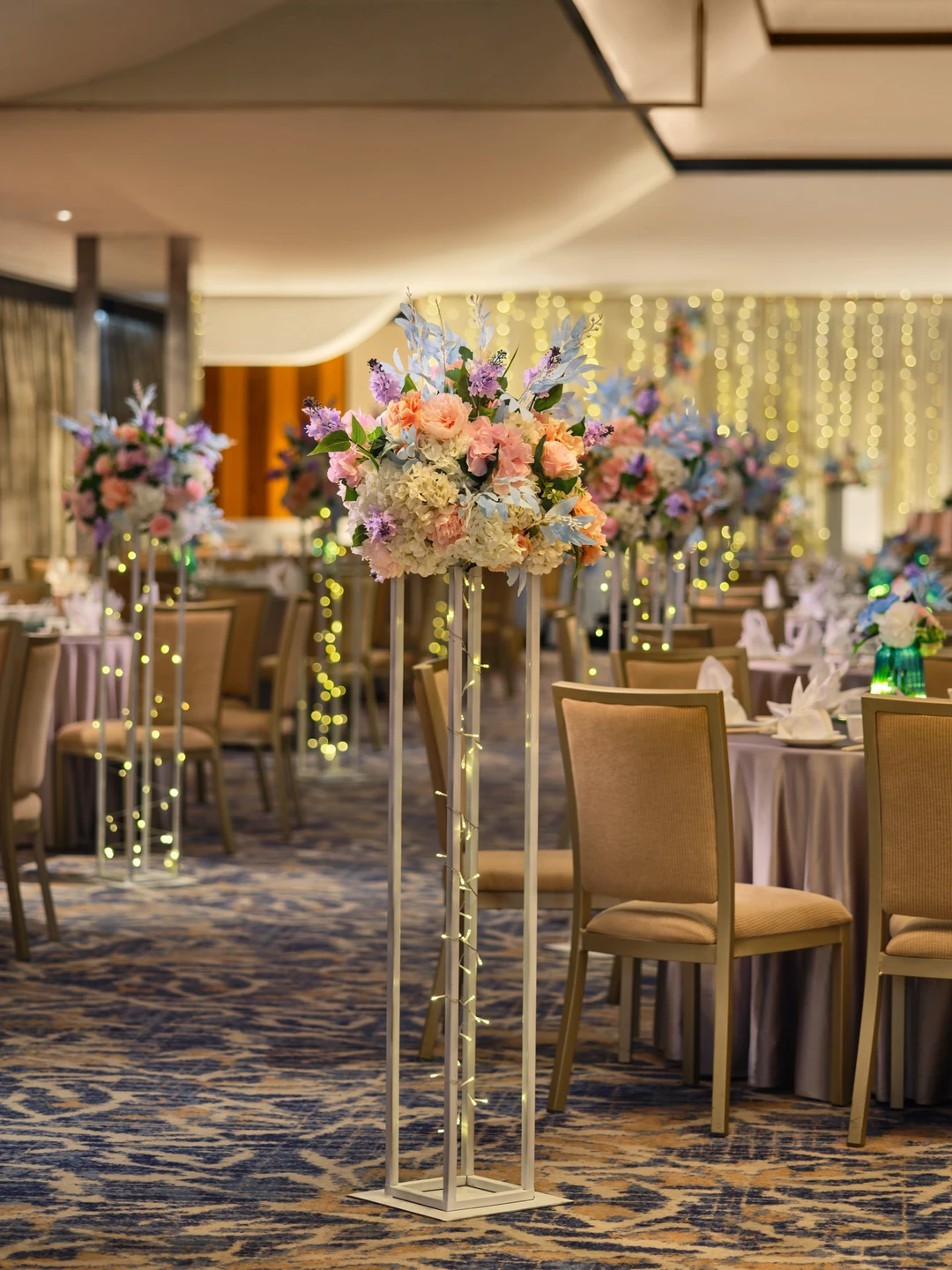 White floral aisle stands with peach roses and fairy lights - voco Orchard Singapore wedding venue photography