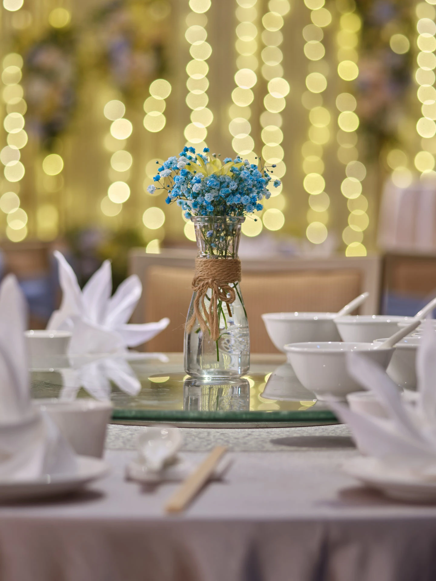 Blue baby's breath centrepiece with fairy-light bokeh backdrop - voco Orchard Singapore wedding photography