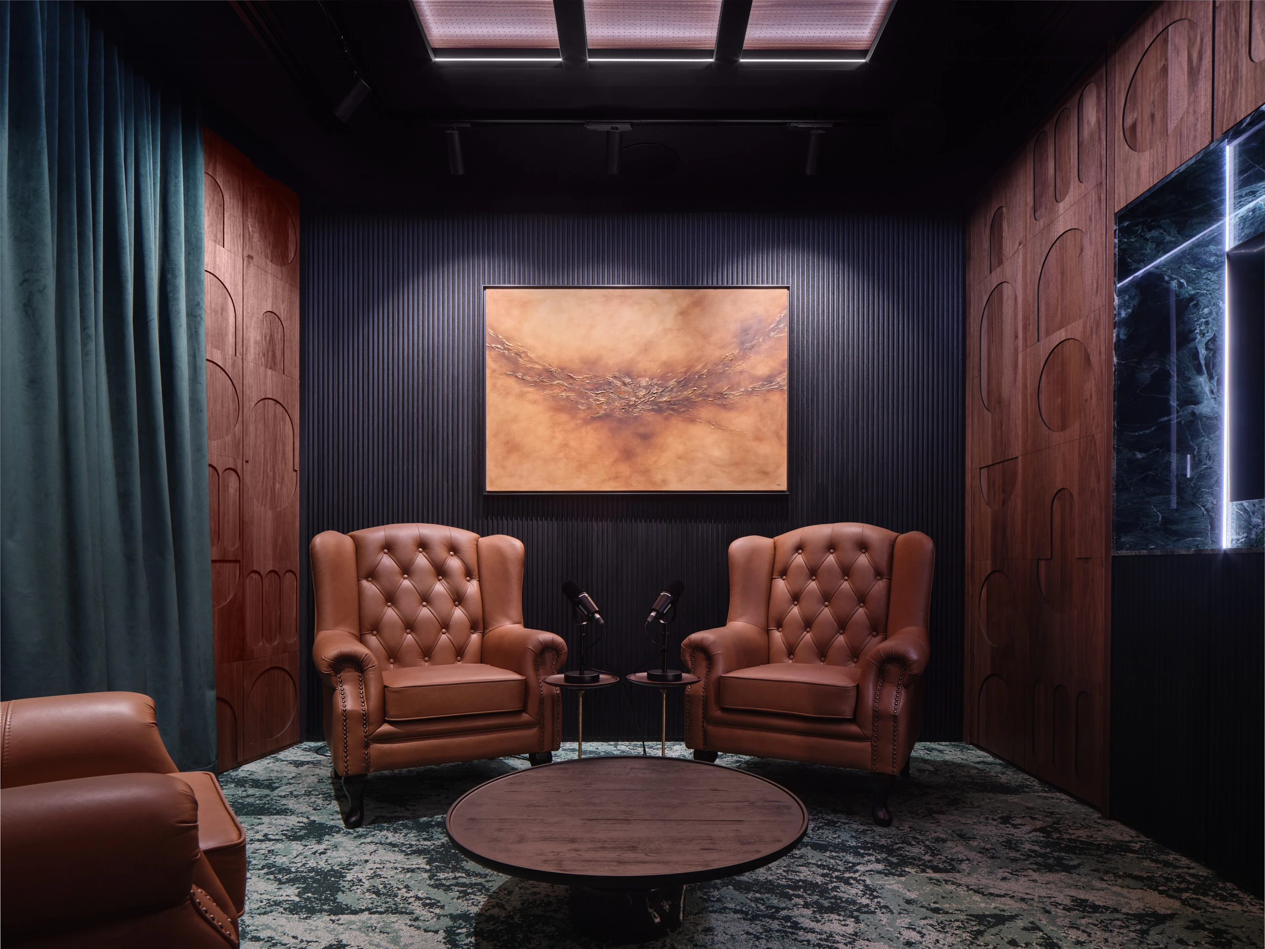 Private meeting lounge with leather armchairs and framed artwork