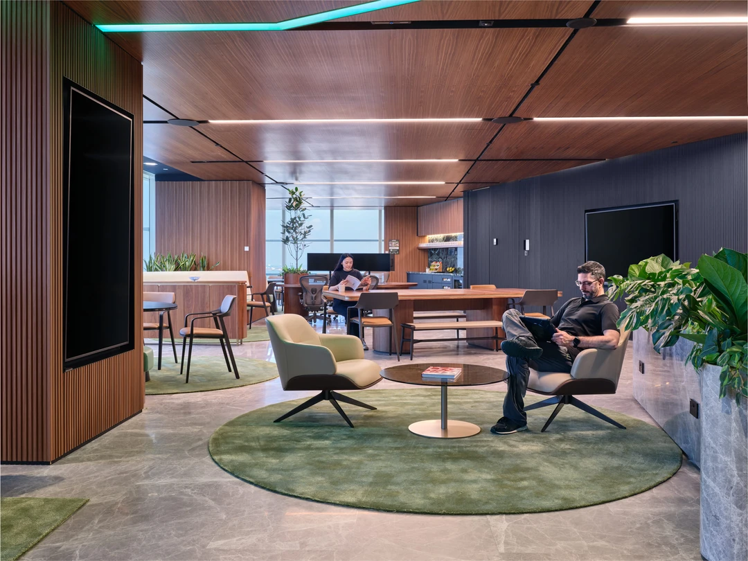Breakout space with circular rug and statement pendant light