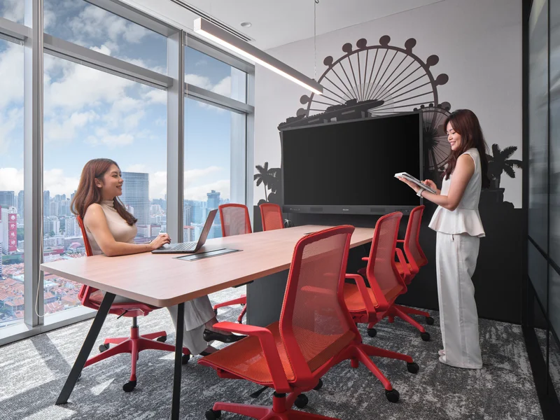 Meeting room with Singapore Flyer wall graphic and red mesh chairs