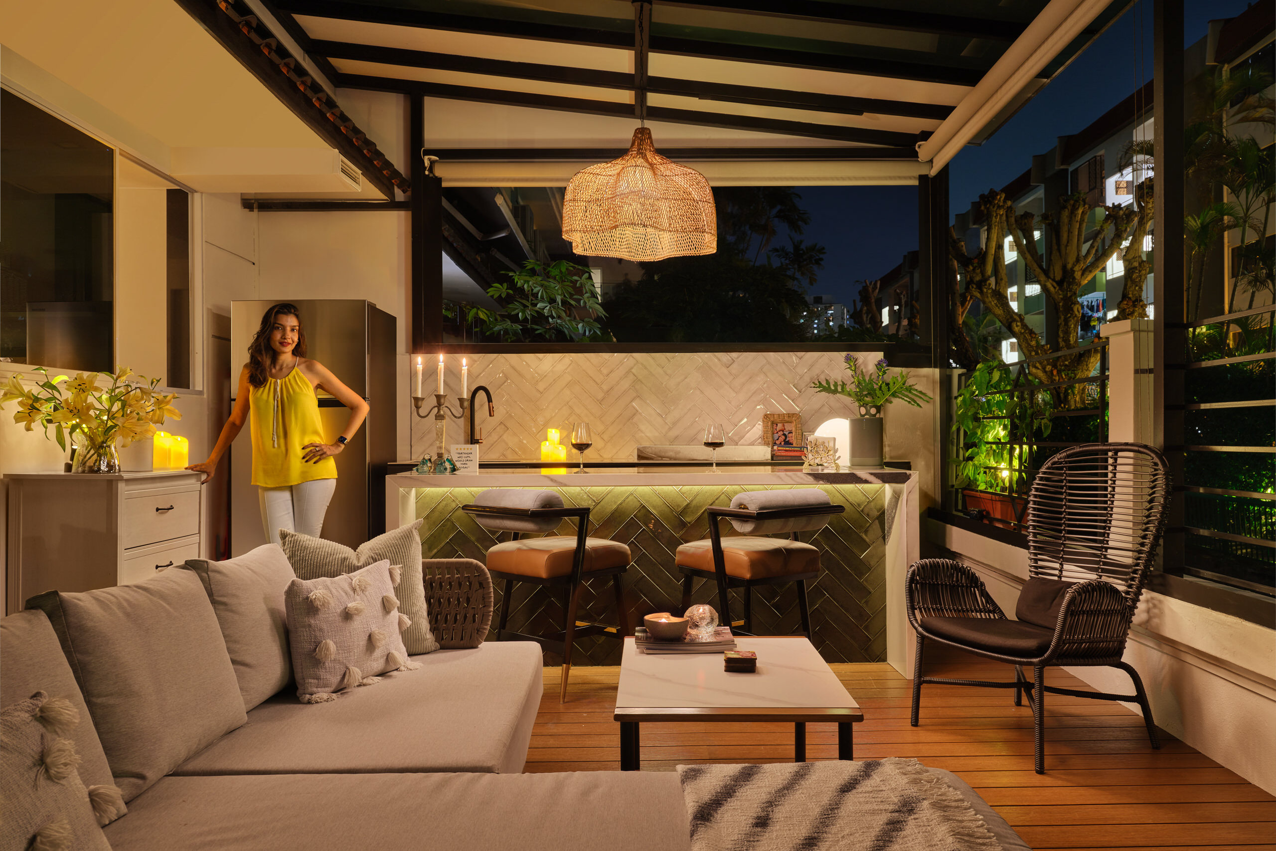 Residential interior design photography of a stylish outdoor bar in East Coast Singapore, with a relaxed atmosphere, pendant lighting, and wooden accents.