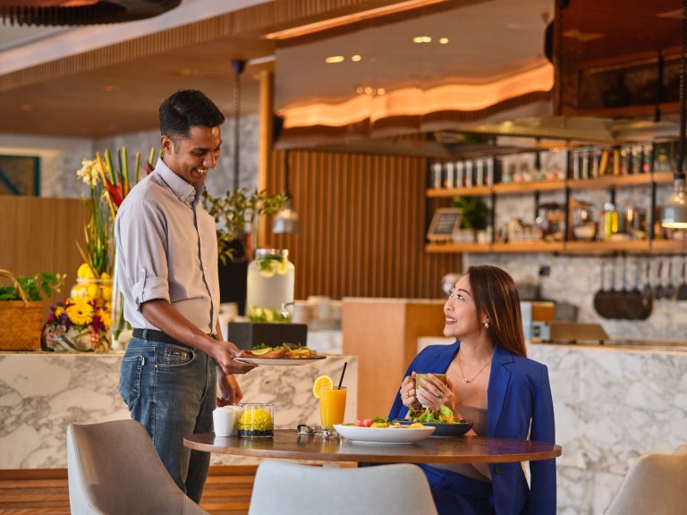 Hilton Garden Inn Singapore Serangoon restaurant lifestyle photography, couple dining at breakfast with fresh food and drinks. Hotel photography by Christopher O'Grady.